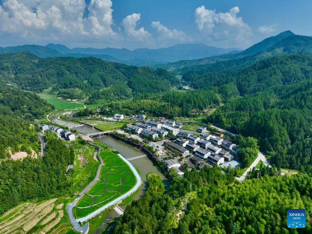 An aerial drone photo shows a view of Chongji Village of Taining County, Sanming City, southeast China's Fujian Province, Aug. 11, 2024. Sanming City has been exploring a new path of development that embraces green transformation to boost rural tourism including forest-based health services and other economic activities. Currently, forests cover 77.12 percent of the total area in the city. （Photo: Xinhua)