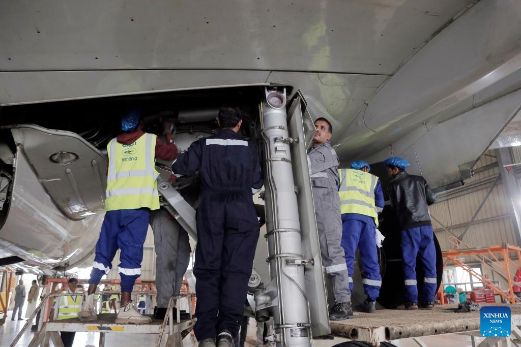 Engineers check an aircraft at the aircraft maintenance center of the Sanaa International Airport, in Sanaa, Yemen, on Aug. 11, 2024. The General Authority of Civil Aviation and Meteorology of Yemen, along with Yemeni Airlines, announced the reopening of the plane maintenance center at the Sanaa International Airport on Sunday. （Photo: Xinhua)