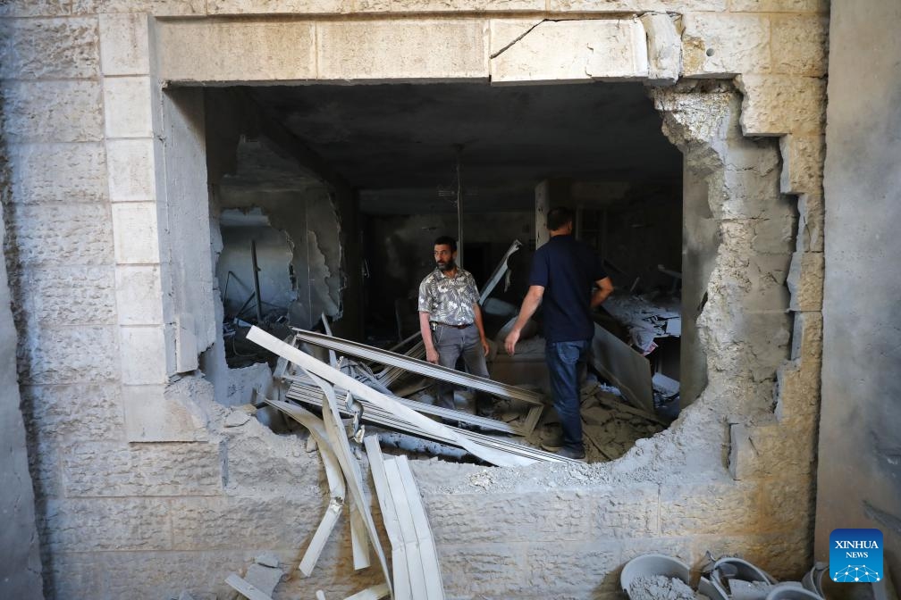 People are seen in an apartment demolished by Israeli forces in the West Bank city of Ramallah, on Aug. 13, 2024. (Photo: Xinhua)