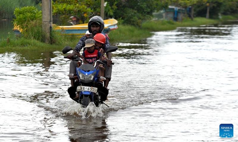 A motorcyclist rides on a waterlogged road in Wattala, Sri Lanka, on Aug. 18, 2024. Photo: Xinhua