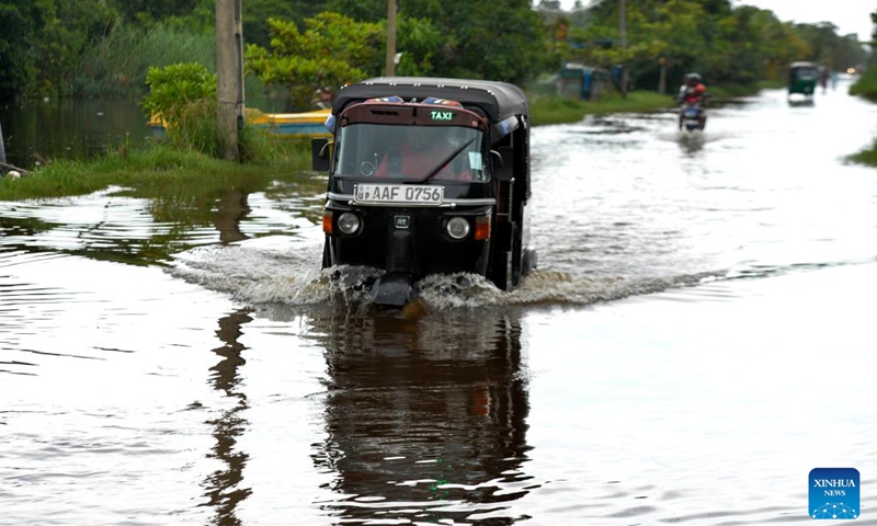 A car rides on a waterlogged road in Wattala, Sri Lanka, on Aug. 18, 2024. Photo: Xinhua