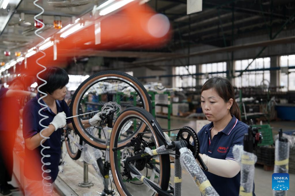 Workers assemble parts at a children wheels factory in Pingxiang County, north China's Hebei Province, Aug. 19, 2024. Pingxiang, dubbed the city of children wheels, has made great efforts in boosting its children wheels business in recent years. Products here have been sold to over 60 countries and regions including Russia, Britain, Kazakhstan and Thailand. The annual revenue of children wheels-related companies in the county has amounted to 30 billion yuan (about 4.20 billion U.S. dollars). (Photo: Xinhua)