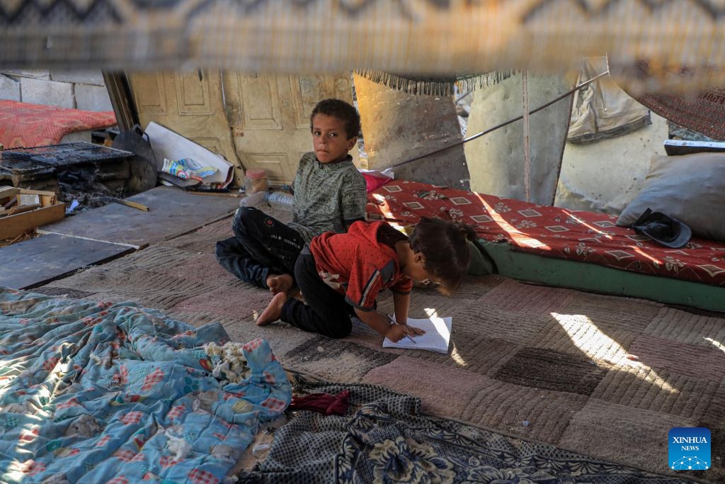 Palestinian children rest on soft mattress at a relocation site in the southern Gaza Strip city of Khan Younis, Aug. 20, 2024. (Photo: Xinhua)