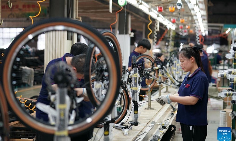 Workers assemble parts at a children wheels factory in Pingxiang County, north China's Hebei Province, Aug. 19, 2024. Pingxiang, dubbed the city of children wheels, has made great efforts in boosting its children wheels business in recent years. Products here have been sold to over 60 countries and regions including Russia, Britain, Kazakhstan and Thailand. The annual revenue of children wheels-related companies in the county has amounted to 30 billion yuan (about 4.20 billion U.S. dollars). (Photo: Xinhua)