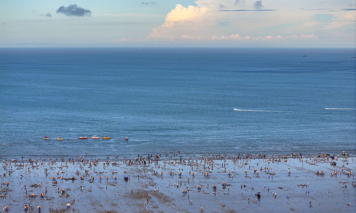 Longwangtou Beach in Fuzhou, East China's Fujian Province, with its clear water and golden sand, attracts tourists from around the world to enjoy the beautiful seascapes and watch sports events on August 21, 2024. Photo: VCG