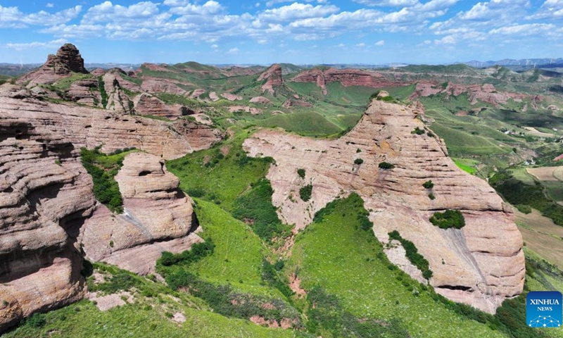 An aerial drone photo shows the Danxia landform at the Huoshizhai National Geological (Forest) Park in Xiji County of Guyuan, northwest China's Ningxia Hui Autonomous Region, Aug. 18, 2024. The park is famous for its Danxia landform, a unique type of geomorphology formed from red-colored sandstones and characterized by steep cliffs. (Photo: Xinhua)