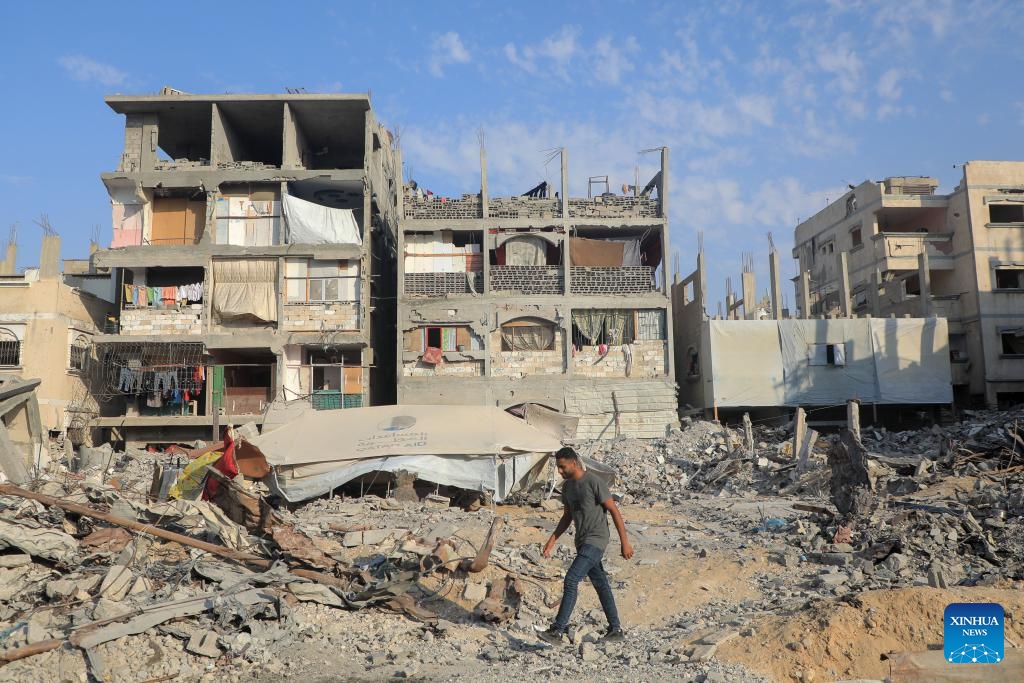 A man walks among rubble of damaged buildings in the southern Gaza Strip city of Khan Younis, on Aug. 26, 2024. (Photo: Xinhua)