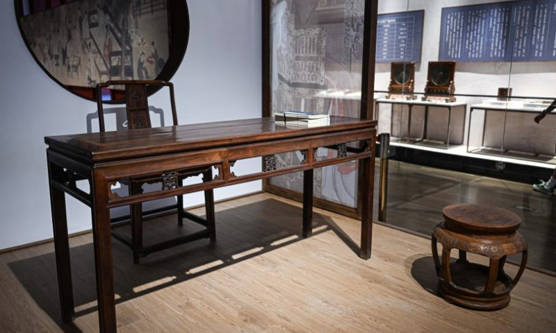 This photo taken on Aug. 31, 2024 shows traditional furniture made of Hainan dalbergia odorifera in Qing Dynasty (1644-1911) at Hainan Museum in Haikou, south China's Hainan Province. An ongoing exhibition showcasing Hainan's cultural relics collected by the Palace Museum is held at Hainan Museum. A total of 96 exhibits with Hainan characteristics are on display including traditional furniture, ornaments and stationery, etc. (Xinhua/Pu Xiaoxu)