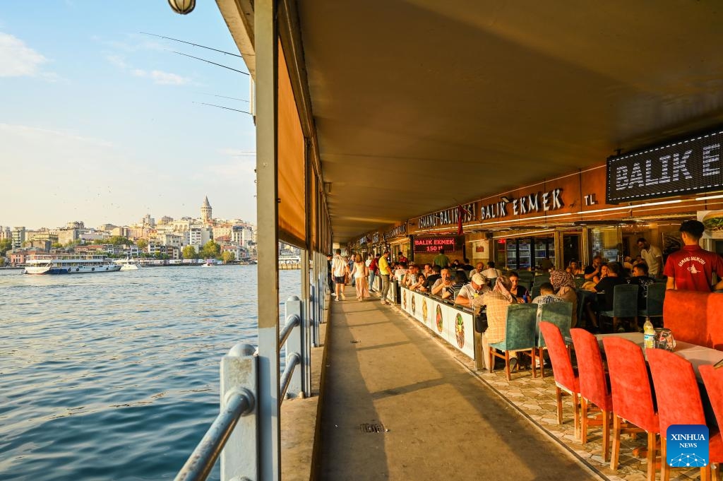 This photo taken on Aug. 29, 2024 shows floating restaurants at the Golden Horn in Istanbul, Türkiye. The Golden Horn, once an important port for trade fleets of the Ottoman Empire and the Eastern Roman Empire, is a famous local tourist attraction nowadays. (Photo: Xinhua)