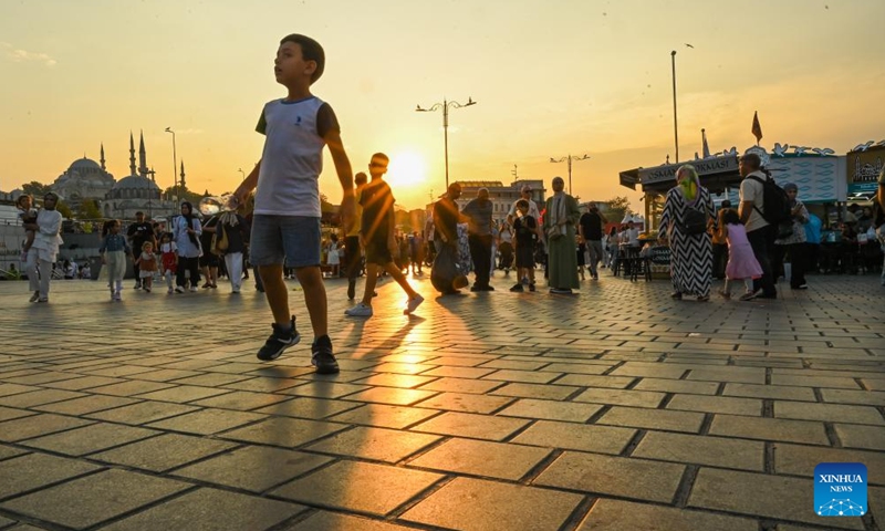 Tourists walk in a square on the shore of the Golden Horn in Istanbul,Türkiye, Aug. 29, 2024. The Golden Horn, once an important port for trade fleets of the Ottoman Empire and the Eastern Roman Empire, is a famous local tourist attraction nowadays. (Photo: Xinhua)