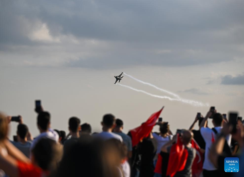 People watch an aircraft performing during an airshow in Istanbul, Türkiye, on Aug. 30, 2024. (Photo: Xinhua)
