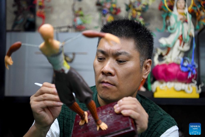 Song Zhanke makes a dough sculpture of Chinese mythological figure the Monkey King or Sun Wukong, at his studio in Luoyang, central China's Henan Province, Aug. 27, 2024. The dough handicraft takes wheat and glutinous rice flour as its main building materials, which are mixed with oil, salt, vinegar and other ingredients. Using hands and simple tools, an artist kneads and pinches the dough to turn it into intricate and lifelike figures.
Song Zhanke, 46, is an inheritor of Song's dough sculpture, a renowned dough handicraft in Luoyang. Having lived by the profession for 20 plus years, the inheritor believes that the figure's body-head proportion, gestures, and facial expressions hold the key to this craft. It is not only the practice of a skill, but also a pursuit and perception of beauty, Song said.
Song hopes that the craft will be better received among younger people and passed down to the future generations. Photo: Xinhua