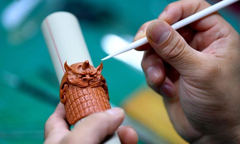 Song Zhanke makes a dough miniature of armour of Chinese mythological figure the Monkey King or Sun Wukong, at his studio in Luoyang, central China's Henan Province, Aug. 27, 2024. The dough handicraft takes wheat and glutinous rice flour as its main building materials, which are mixed with oil, salt, vinegar and other ingredients. Using hands and simple tools, an artist kneads and pinches the dough to turn it into intricate and lifelike figures.
Song Zhanke, 46, is an inheritor of Song's dough sculpture, a renowned dough handicraft in Luoyang. Having lived by the profession for 20 plus years, the inheritor believes that the figure's body-head proportion, gestures, and facial expressions hold the key to this craft. It is not only the practice of a skill, but also a pursuit and perception of beauty, Song said.
Song hopes that the craft will be better received among younger people and passed down to the future generations. Photo: Xinhua