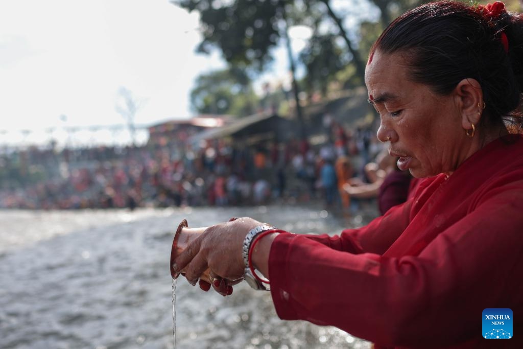 A woman performs a ritual during Kuse Aunsi, or Father's Day, at Gokarna Temple on the bank of Bagmati River in Kathmandu, Nepal, Sept. 2, 2024. Kuse Aunsi is a Hindu festival in which fathers, living or past, are honored. (Photo: Xinhua)