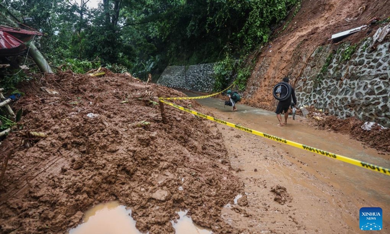 Residents walk past the site of a landslide due to the heavy rains brought by tropical storm Yagi in Rizal Province, the Philippines, on Sept. 2, 2024. Floods and landslides triggered by tropical storm Yagi have killed at least 10 people and left at least one missing, authorities said Monday. (Photo: Xinhua)