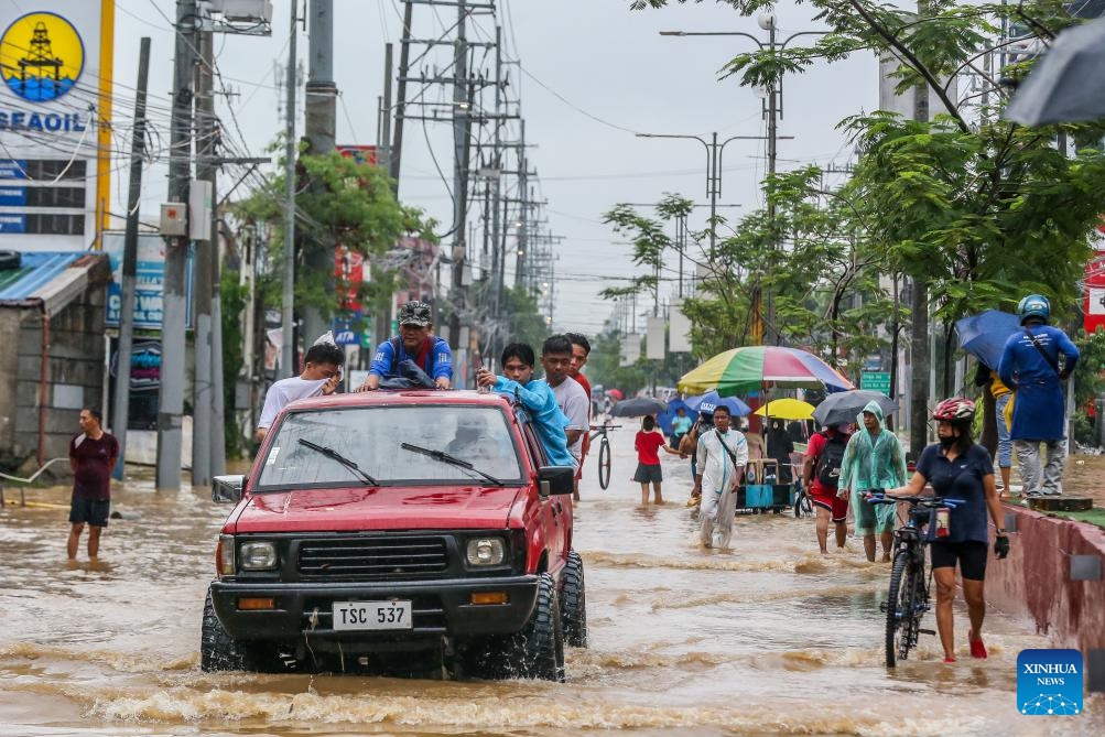 Residents wade through the flood brought by tropical storm Yagi in Rizal Province, the Philippines, on Sept. 2, 2024. Floods and landslides triggered by tropical storm Yagi have killed at least 10 people and left at least one missing, authorities said Monday. (Photo: Xinhua)
