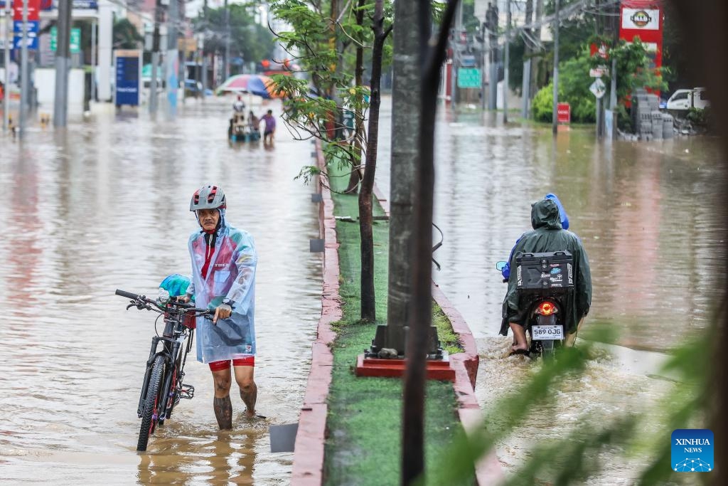 Residents wade through the flood brought by tropical storm Yagi in Rizal Province, the Philippines, on Sept. 2, 2024. Floods and landslides triggered by tropical storm Yagi have killed at least 10 people and left at least one missing, authorities said Monday. (Photo: Xinhua)