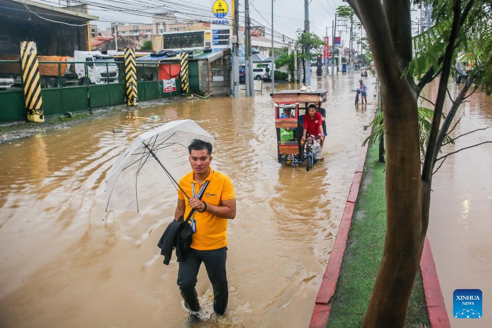 Residents wade through the flood brought by tropical storm Yagi in Rizal Province, the Philippines, on Sept. 2, 2024. Floods and landslides triggered by tropical storm Yagi have killed at least 10 people and left at least one missing, authorities said Monday. (Photo: Xinhua)