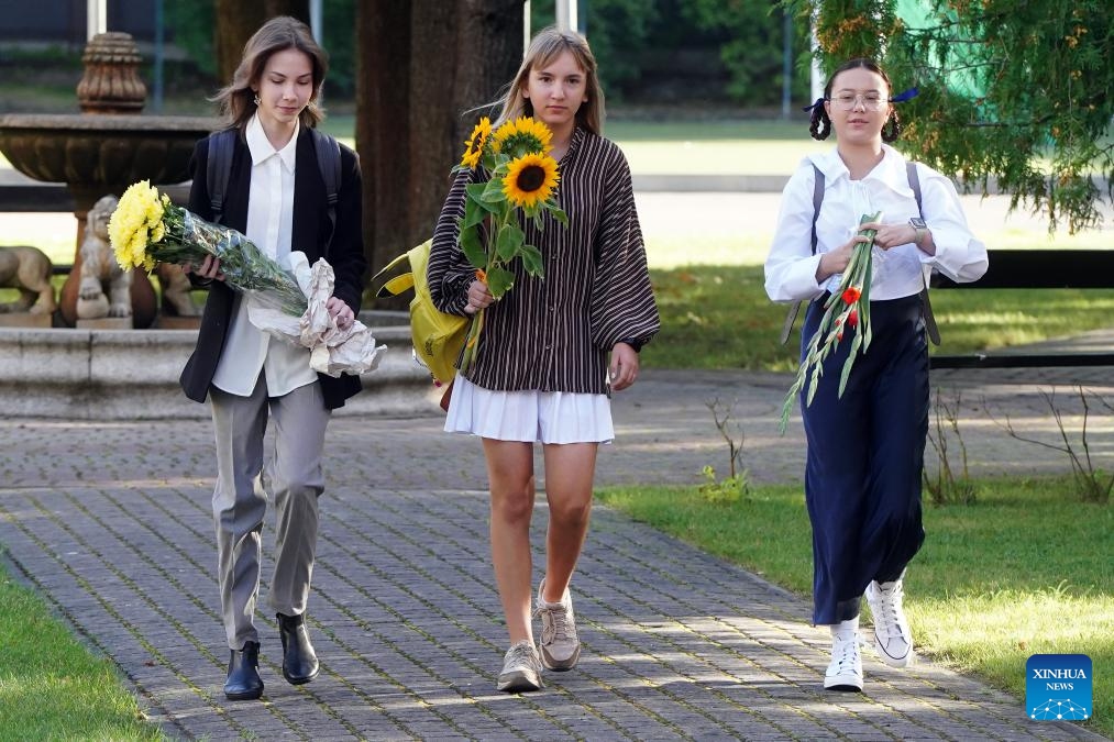 Students holding bouquets are seen on the first day of the new school year in Riga, Latvia, Sept. 2, 2024. The new school year started for students from the first to the 12th grade in Latvia on Monday. Students go to school with flowers on the first day of the new school year. (Photo: Xinhua)