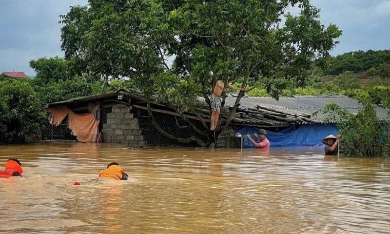 Rescuers help people evacuate from a flooded area in Vietnam's northern province of Bac Ninh, Sept. 8, 2024. (VNA via Xinhua)