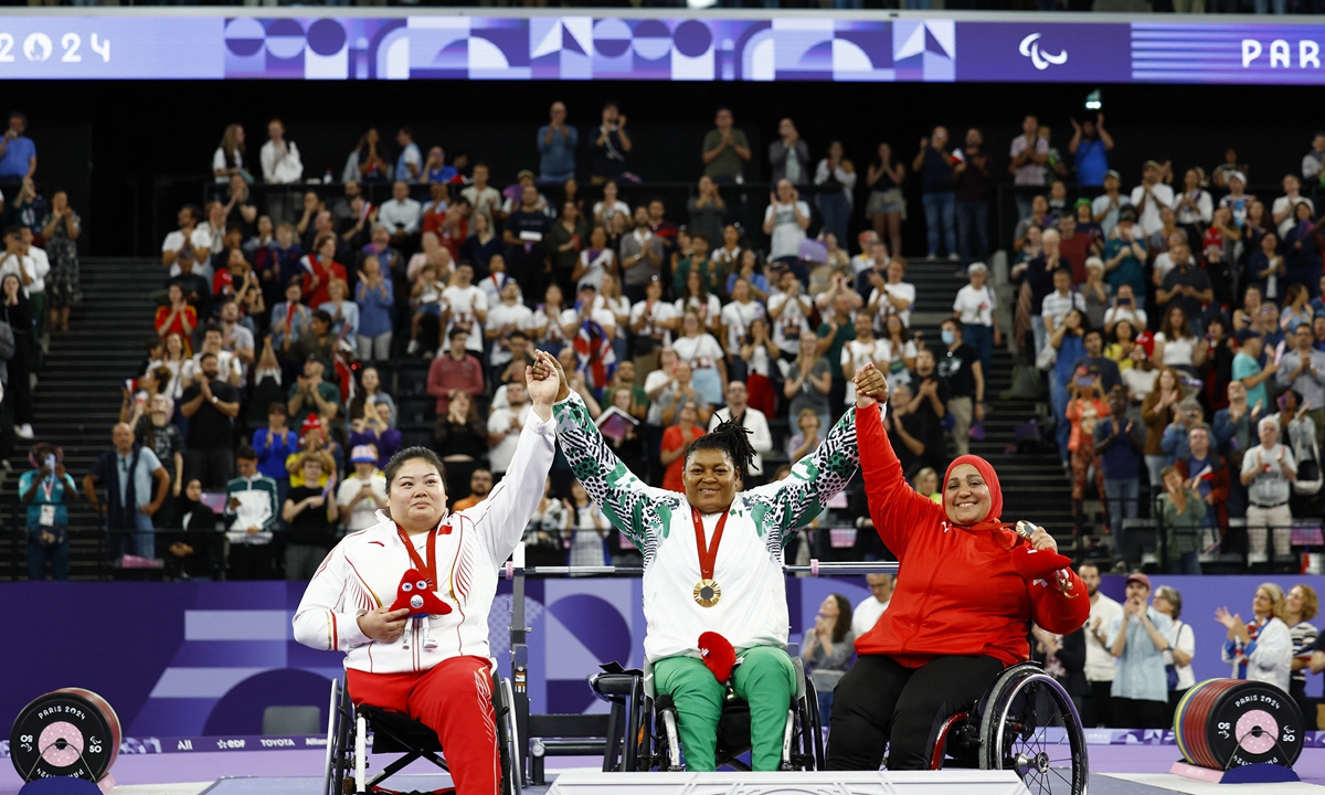 Chinese athlete Deng Xuemei, who won a silver in the women's over 86kg powerlifting, poses with Nigeria's gold winner Folashade Oluwafemiayo and Egypt's bronze winner Nadia Ali on September 8, 2024, the last competition day of the Paris 2024 Paralympic Games. China secured 94 golds, 76 silvers and 50 bronzes at the Paralympics, far leading the medal table. Photo: IC