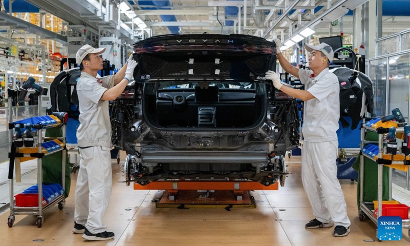 Workers install the rear lights to a vehicle at an assembly line of Dongfeng Motor Corporation in Wuhan, central China's Hubei Province, Sept. 6, 2024. (Photo: Xinhua)