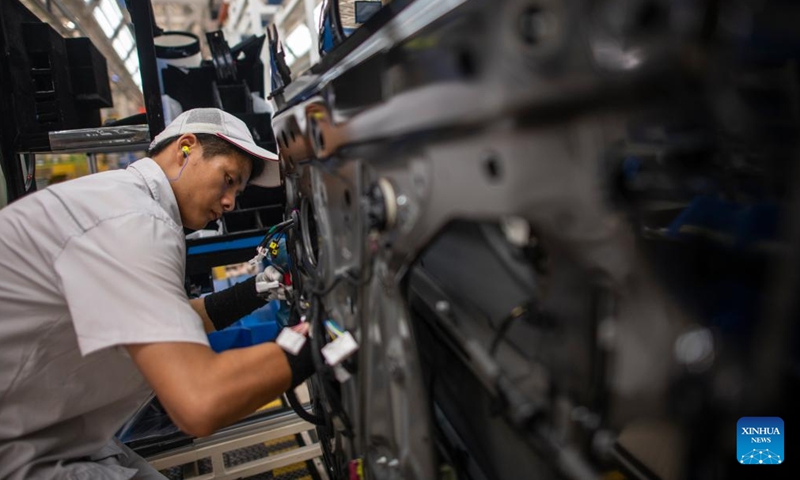 A worker installs the cables to a vehicle at an assembly line of Dongfeng Motor Corporation in Wuhan, central China's Hubei Province, Sept. 6, 2024. (Photo: Xinhua)