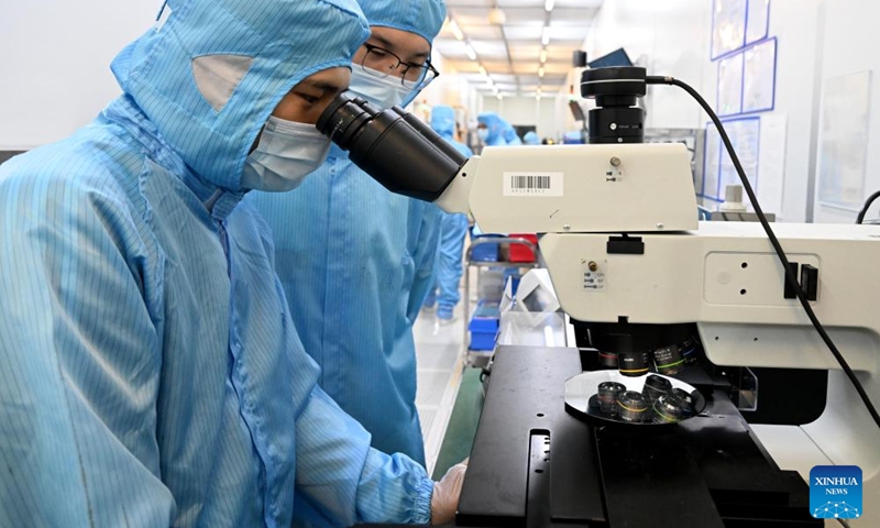 Staff of Anhui North Microelectronics Research Institute Group Corporation Limited check on MEMS wafers in the China Sensor Valley at Bengbu City, east China's Anhui Province, Sept. 12, 2024. China Speech Valley in Hefei City, the Vision Valley of China in Wuhu City and China Sensor Valley in Bengbu City, are three key demonstration zones for the artificial intelligence (AI) industry in Anhui Province. (Photo: Xinhua)