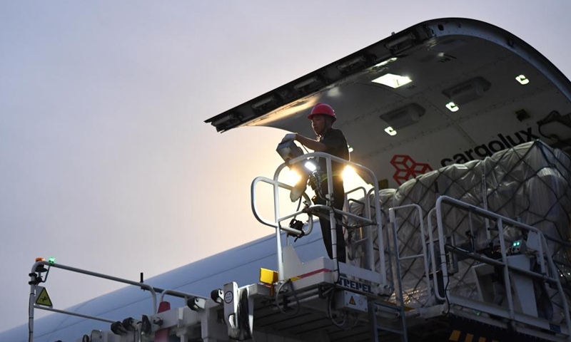 A staff member loads a cargo plane at Xinzheng International Airport in Zhengzhou, central China's Henan Province, Aug. 1, 2023. Strategically positioned in central part of the country, Henan has been serving as a national hub of transporation for ages. The past decades saw the province building a modern transportation network consisting air flights, railways, highways, water channels and all sorts of ports. It is now rapidly extending its role to areas of cross-border logistics, investment, and trade to facilitate the dual circulation of domestic and international markets. Photo: Xinhua