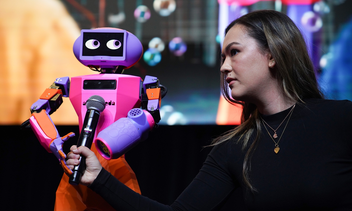 Grace Brown (right), CEO of Andromeda Robotics speaks to Abi, a humanoid companion robot during the launch of Australian AI Month at South by SouthWest (SXSW) Sydney - Australia's most influential tech and innovation expo on October 16, 2024 in Sydney, Australia. Photo: VCG