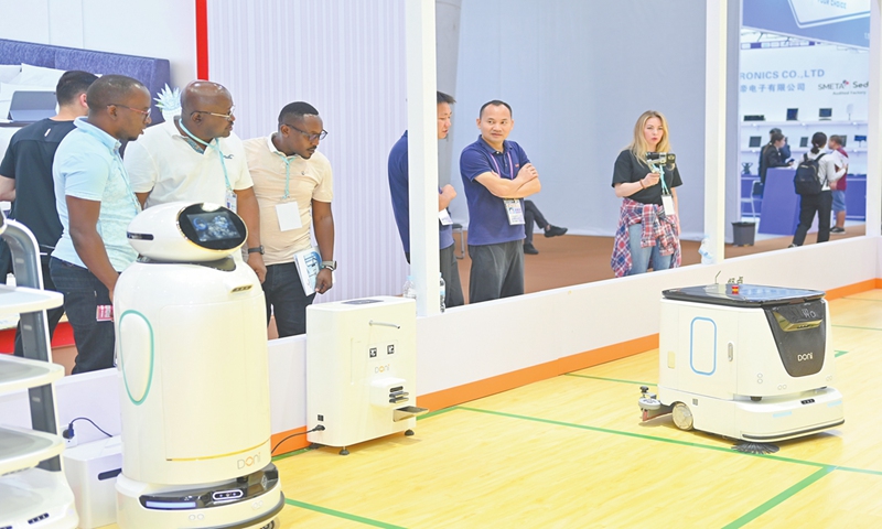 Overseas buyers explore intelligent robots displayed at a booth of the 136th Canton Fair in Guangzhou, South China's Guangdong Province on October 17, 2024. More than 8,000 exhibitors have been recognized as national high-tech enterprises,