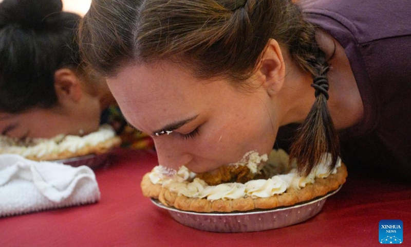 People compete during the pumpkin pie eating contest at Metrotown Shopping Mall in Burnaby, British Columbia, Canada, Oct. 19, 2024.
The competition required participants to finish as much of a 2-pound pie as possible in 5 minutes without using their hands. (Photo: Xinhua)