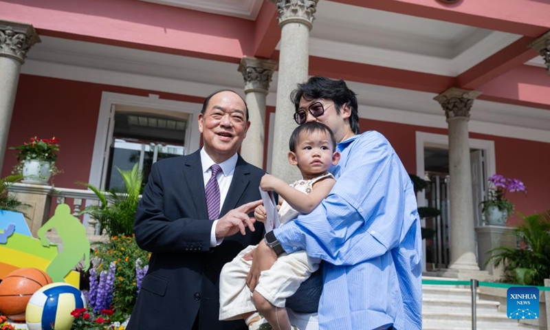 Ho Iat Seng (1st L), chief executive of China's Macao Special Administrative Region (SAR), poses for a photo with visitors at the government headquarters of the Macao Special Administrative Region on the open day in Macao, south China, Oct. 27, 2024. (Photo: Xinhua)