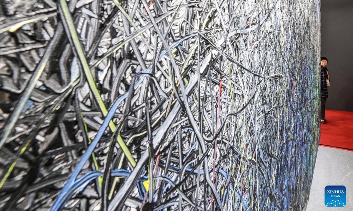A visitor looks at an artwork at the Antiques and Fine Art exhibition area during the 7th China International Import Expo (CIIE) in east China's Shanghai, Nov. 7, 2024. The Antiques and Fine Art exhibition area has been set up for four consecutive years at CIIE.   (Photo: Xinhua)