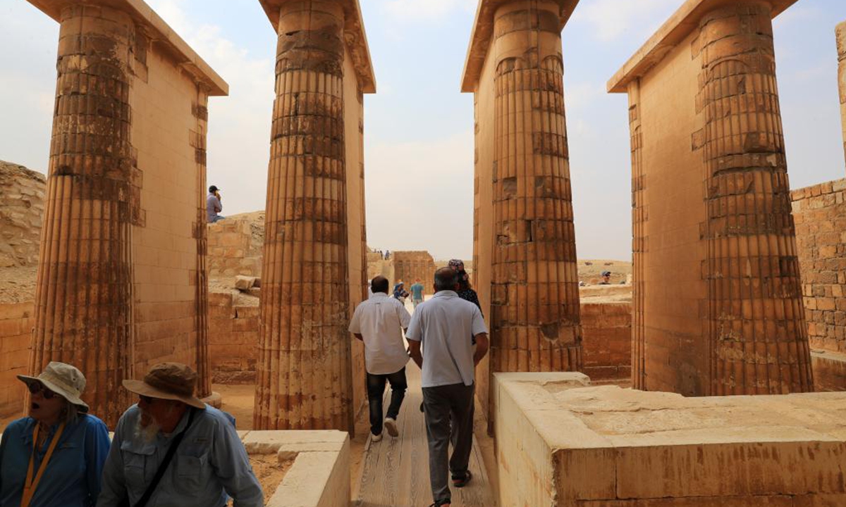 Tourists visit the Step Pyramid complex in the Saqqara necropolis, south of Cairo, Egypt, on Nov. 12, 2024. The Step Pyramid, a UNESCO World Heritage Site, was designed and built by the architect Imhotep in the 27th century BC during the Third Dynasty to hold the mummy of Pharaoh Djoser. (Photo: Xinhua)