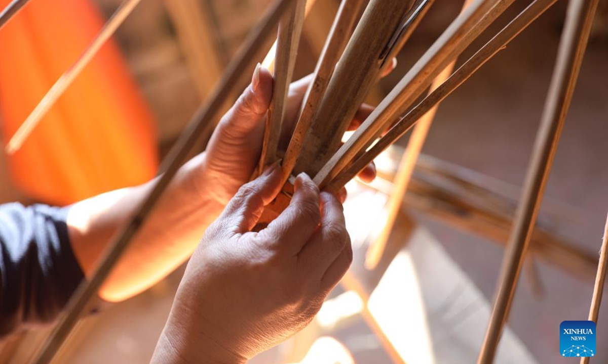 A worker makes ribs for an oilcloth umbrella in Gufeng Village of Jingxian County, east China's Anhui Province, Nov. 13, 2024. The umbrella, made of oiled cloth and bamboo frame, is a traditional Chinese handicraft. (Photo: Xinhua)