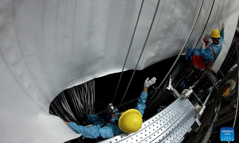 This photo taken on Nov. 23, 2024 shows the acrylic sphere of the central detector of the Jiangmen Underground Neutrino Observatory (JUNO) being cleaned in Jiangmen, south China's Guangdong Province.(Xinhua/Jin Liwang)
