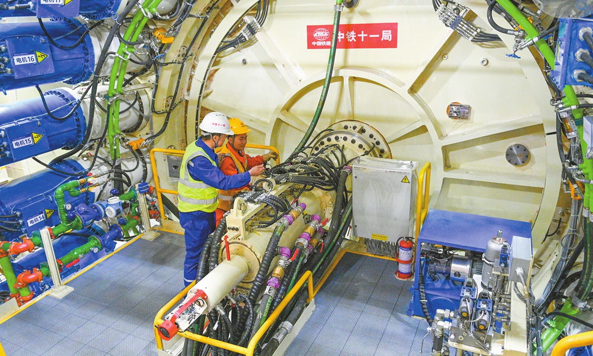 Workers inspect a tunnel boring machine in Chengdu, Southwest China's Sichuan Province on November 27, 2024. The 14-meter diameter