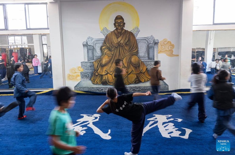 Students practice Tai Chi at a martial arts school in Shiyan City in central China's Hubei Province, Nov. 28, 2024. Tai Chi, a centuries-old Chinese martial art focusing on both internal and external practices, involves a series of slow, gentle movements and physical postures, a meditative state of mind, and controlled breathing. Statistics show that over 100 million people across more than 150 countries and regions practice Tai Chi, with about 30,000 foreigners traveling to the Wudang Mountain annually to learn and experience it. Photo: Xinhua