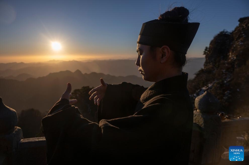 A Taoist priest practices martial arts at golden peak on the Wudang Mountain in Shiyan City in central China's Hubei Province, Nov. 29, 2024. Tai Chi, a centuries-old Chinese martial art focusing on both internal and external practices, involves a series of slow, gentle movements and physical postures, a meditative state of mind, and controlled breathing. Statistics show that over 100 million people across more than 150 countries and regions practice Tai Chi, with about 30,000 foreigners traveling to the Wudang Mountain annually to learn and experience it. Photo: Xinhua