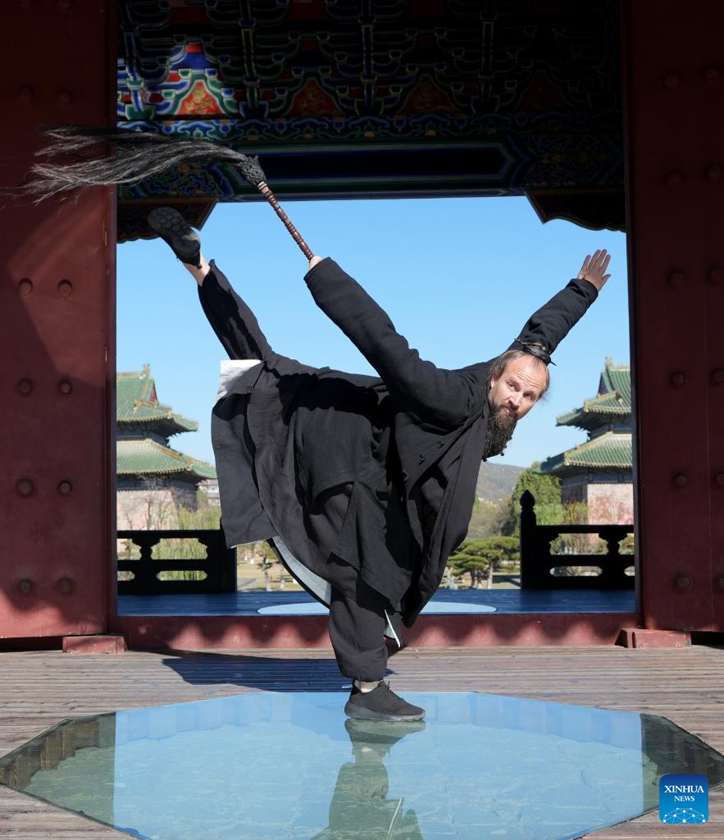 Jake Pinnick practices martial arts at Yuxu Gong Temple in Shiyan City in central China's Hubei Province, Nov. 29, 2024. An American who traveled to the Wudang Mountain to study martial arts in 2010, Jake Pinnick now serves as an instructor, imparting knowledge of Tai Chi and Chinese culture to a global audience. Tai Chi, a centuries-old Chinese martial art focusing on both internal and external practices, involves a series of slow, gentle movements and physical postures, a meditative state of mind, and controlled breathing. Statistics show that over 100 million people across more than 150 countries and regions practice Tai Chi, with about 30,000 foreigners traveling to the Wudang Mountain annually to learn and experience it. Photo: Xinhua