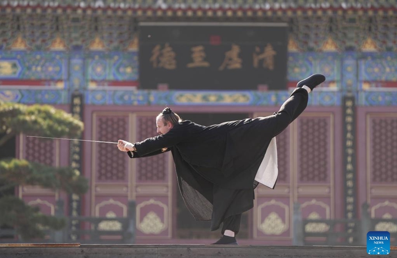 Jake Pinnick practices martial arts at Yuxu Gong Temple in Shiyan City in central China's Hubei Province, Nov. 29, 2024. An American who traveled to the Wudang Mountain to study martial arts in 2010, Jake Pinnick now serves as an instructor, imparting knowledge of Tai Chi and Chinese culture to a global audience. Tai Chi, a centuries-old Chinese martial art focusing on both internal and external practices, involves a series of slow, gentle movements and physical postures, a meditative state of mind, and controlled breathing. Statistics show that over 100 million people across more than 150 countries and regions practice Tai Chi, with about 30,000 foreigners traveling to the Wudang Mountain annually to learn and experience it. Photo: Xinhua