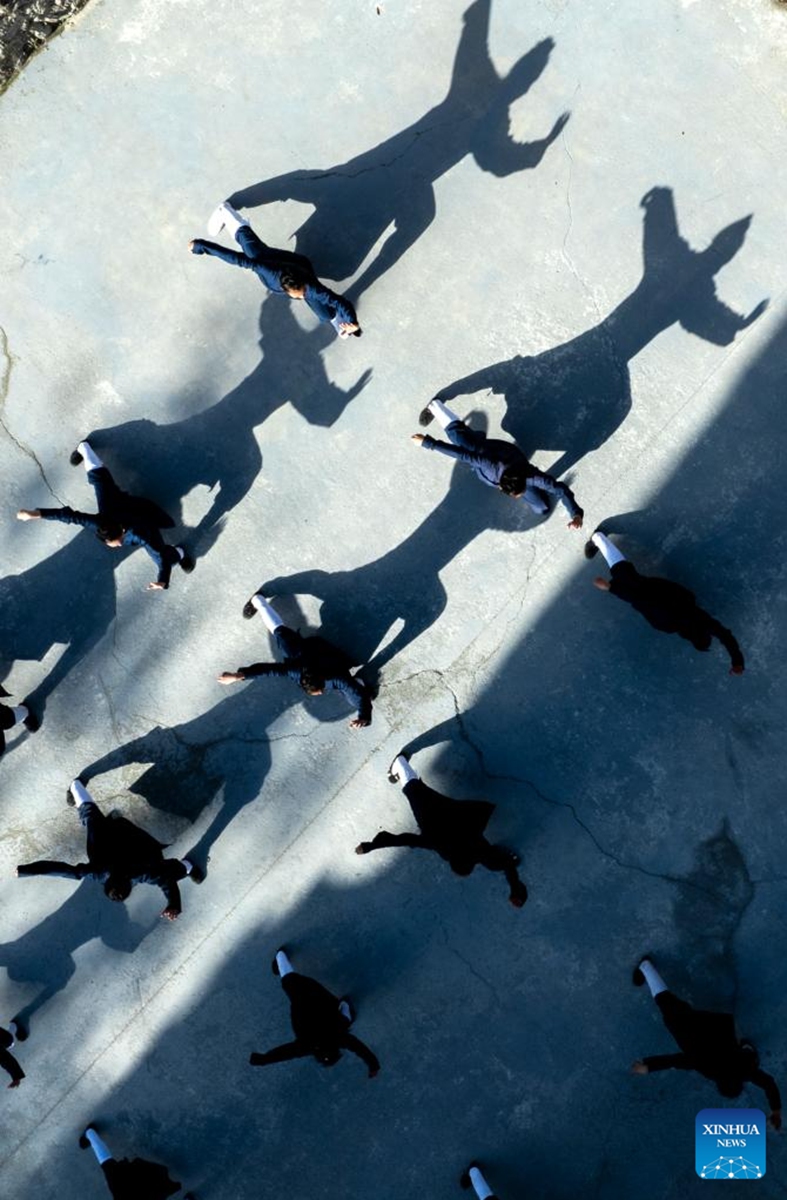An aerial drone photo shows students practicing Tai Chi at a martial arts school in Shiyan City in central China's Hubei Province, Nov. 28, 2024. Tai Chi, a centuries-old Chinese martial art focusing on both internal and external practices, involves a series of slow, gentle movements and physical postures, a meditative state of mind, and controlled breathing. Statistics show that over 100 million people across more than 150 countries and regions practice Tai Chi, with about 30,000 foreigners traveling to the Wudang Mountain annually to learn and experience it. Photo: Xinhua