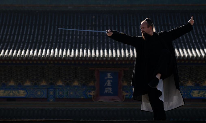 Jake Pinnick practices martial arts at Yuxu Gong Temple in Shiyan City in central China's Hubei Province, Nov. 29, 2024. An American who traveled to the Wudang Mountain to study martial arts in 2010, Jake Pinnick now serves as an instructor, imparting knowledge of Tai Chi and Chinese culture to a global audience. Tai Chi, a centuries-old Chinese martial art focusing on both internal and external practices, involves a series of slow, gentle movements and physical postures, a meditative state of mind, and controlled breathing. Statistics show that over 100 million people across more than 150 countries and regions practice Tai Chi, with about 30,000 foreigners traveling to the Wudang Mountain annually to learn and experience it. Photo: Xinhua