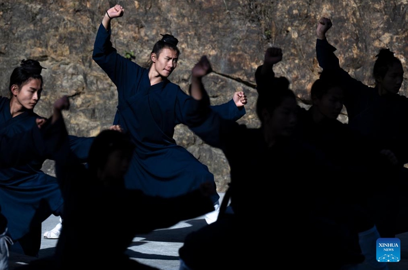 Students practice Tai Chi at a martial arts school in Shiyan City in central China's Hubei Province, Nov. 28, 2024. Tai Chi, a centuries-old Chinese martial art focusing on both internal and external practices, involves a series of slow, gentle movements and physical postures, a meditative state of mind, and controlled breathing. Statistics show that over 100 million people across more than 150 countries and regions practice Tai Chi, with about 30,000 foreigners traveling to the Wudang Mountain annually to learn and experience it. Photo: Xinhua