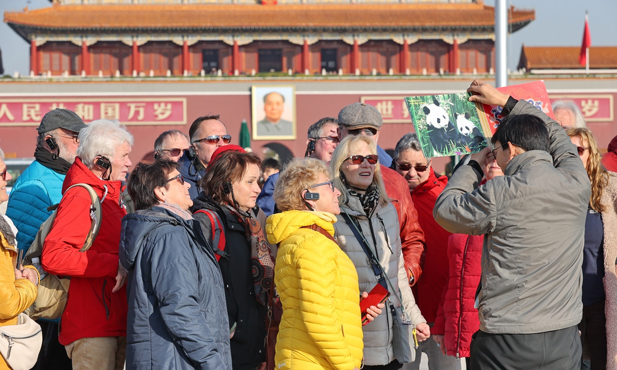 A group of foreign tourists visit Tian'anmen Square in Beijing on December 1, 2024. Data from various entry-exit stations across China indicate a significant increase in international arrivals since a visa-free policy was adopted last year. Photo: VCG
