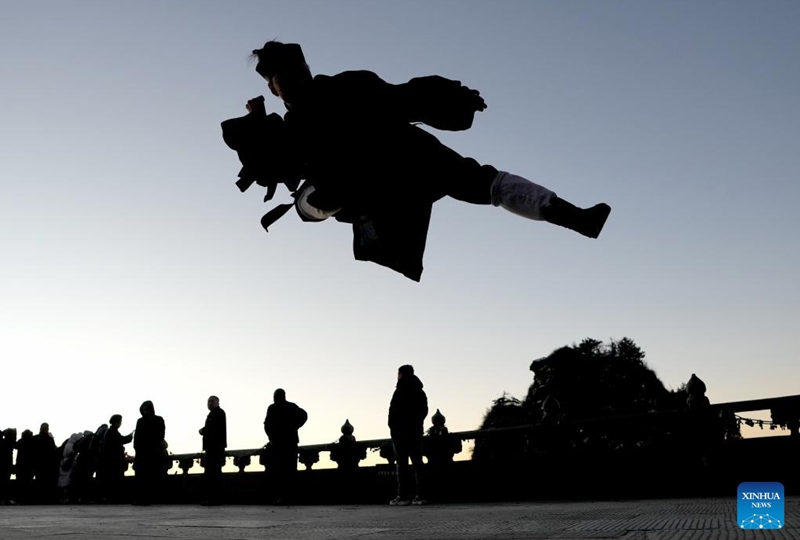 A Taoist priest practices martial arts at golden peak on the Wudang Mountain in Shiyan City in central China's Hubei Province, Nov. 29, 2024. Tai Chi, a centuries-old Chinese martial art focusing on both internal and external practices, involves a series of slow, gentle movements and physical postures, a meditative state of mind, and controlled breathing. Statistics show that over 100 million people across more than 150 countries and regions practice Tai Chi, with about 30,000 foreigners traveling to the Wudang Mountain annually to learn and experience it. Photo: Xinhua
