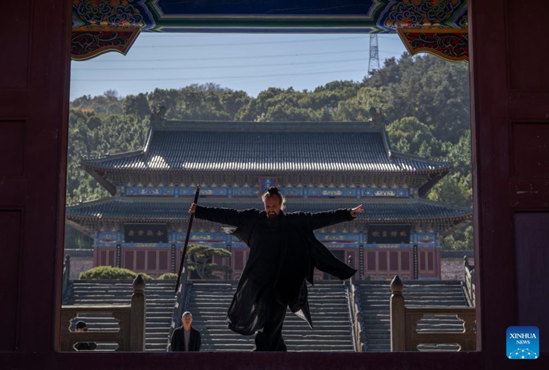 Jake Pinnick practices martial arts at Yuxu Gong Temple in Shiyan City in central China's Hubei Province, Nov. 29, 2024. An American who traveled to the Wudang Mountain to study martial arts in 2010, Jake Pinnick now serves as an instructor, imparting knowledge of Tai Chi and Chinese culture to a global audience. Tai Chi, a centuries-old Chinese martial art focusing on both internal and external practices, involves a series of slow, gentle movements and physical postures, a meditative state of mind, and controlled breathing. Statistics show that over 100 million people across more than 150 countries and regions practice Tai Chi, with about 30,000 foreigners traveling to the Wudang Mountain annually to learn and experience it. Photo: Xinhua