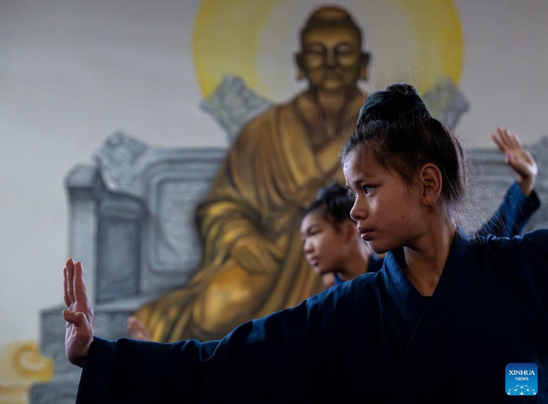Students practice Tai Chi at a martial arts school in Shiyan City in central China's Hubei Province, Nov. 28, 2024. Tai Chi, a centuries-old Chinese martial art focusing on both internal and external practices, involves a series of slow, gentle movements and physical postures, a meditative state of mind, and controlled breathing. Statistics show that over 100 million people across more than 150 countries and regions practice Tai Chi, with about 30,000 foreigners traveling to the Wudang Mountain annually to learn and experience it. Photo: Xinhua
