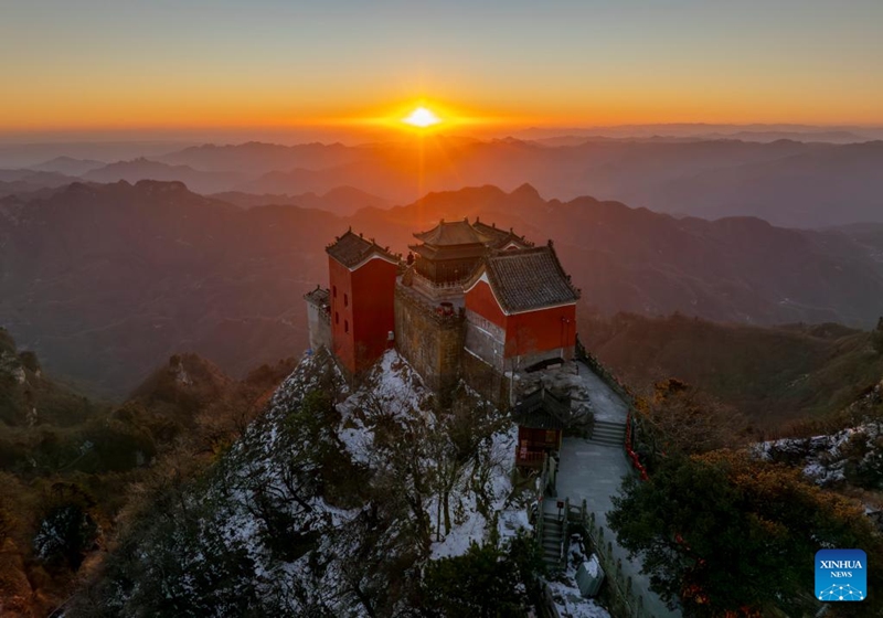 An aerial drone photo shows a view of golden peak on the Wudang Mountain in Shiyan City in central China's Hubei Province, Nov. 29, 2024. Tai Chi, a centuries-old Chinese martial art focusing on both internal and external practices, involves a series of slow, gentle movements and physical postures, a meditative state of mind, and controlled breathing. Statistics show that over 100 million people across more than 150 countries and regions practice Tai Chi, with about 30,000 foreigners traveling to the Wudang Mountain annually to learn and experience it. Photo: Xinhua